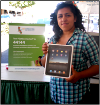 Girl receiving a tablet at a Dewey Square Group Get Connected! event