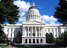 State of California Capitol Building with bright blue sky and clouds floating by